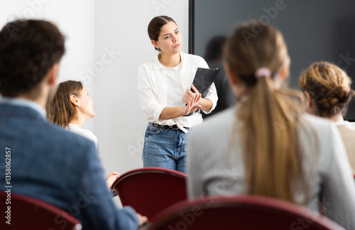 Fotografie Portrait of young businesswoman standing near interactive board and participatin