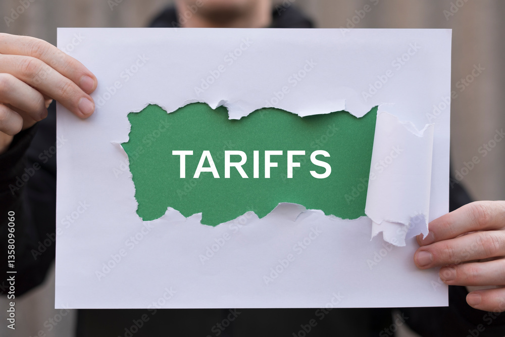 Man holding paper sheets banner with word: TARIFFS. Import Tariffs Increase USA Trade concept. Tariffs Business Barrier International Commerce.