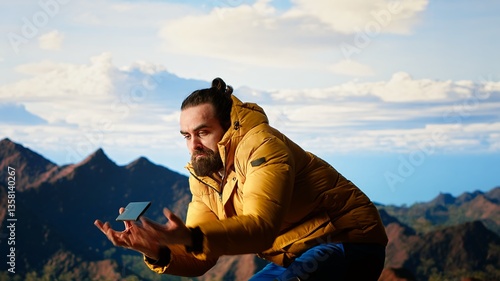 Obraz na plátně Foolish hiker acting careless dropping smartphone and losing balance, person unequipped for the harsh mountain environment