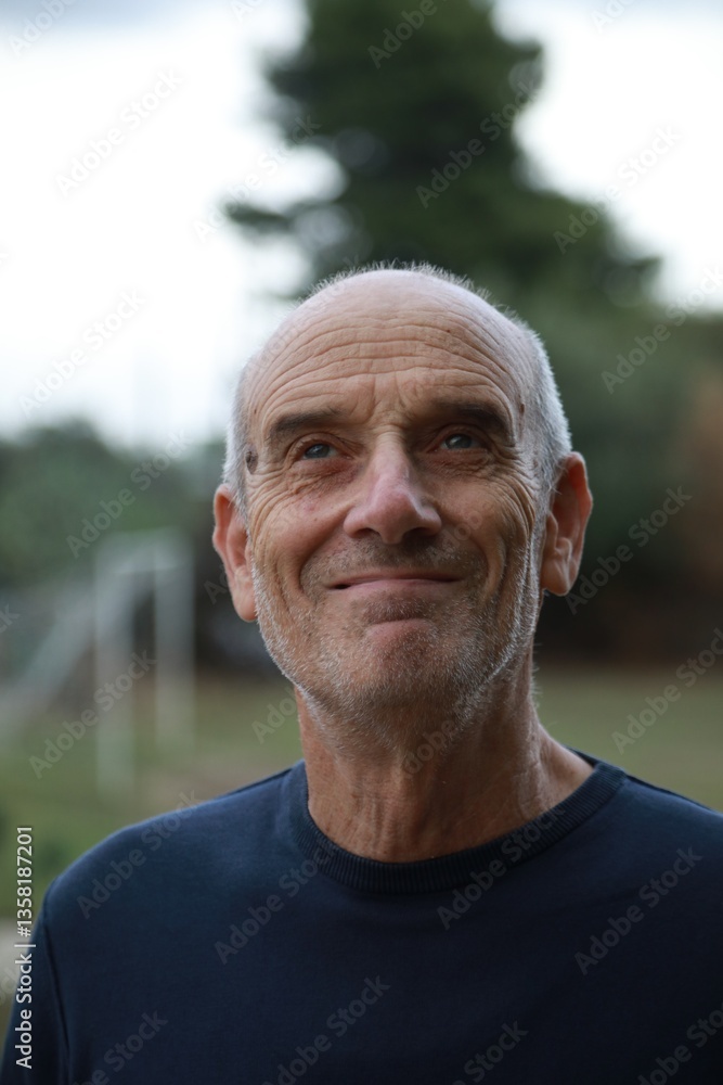 Bald Senior Man Smiles Facial Expression In The Nature Among The Trees Bald Senior Man Smiles Facial Expression In The Nature Among The Trees