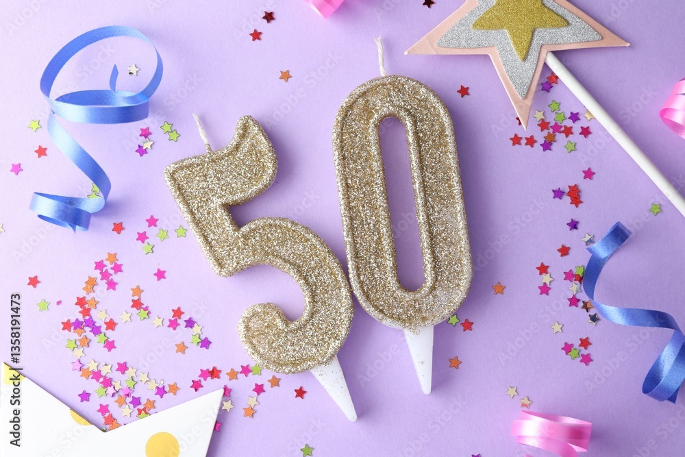 50th birthday. Number shaped candles, confetti and party decor on violet background, flat lay 50th birthday. Number shaped candles, confetti and party decor on violet background, flat lay