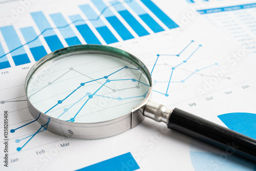 Magnifying glass on charts graphs paper. Financial development, Banking Account, Statistic, Investment Analytic research data economy.