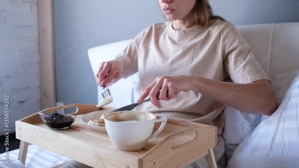 young Caucasian woman having breakfast in bed at home young Caucasian woman having breakfast in bed at home