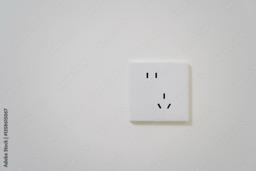White Electrical Outlet and Wall Plate at the white wall, symbolizing energy connection and electrical power source