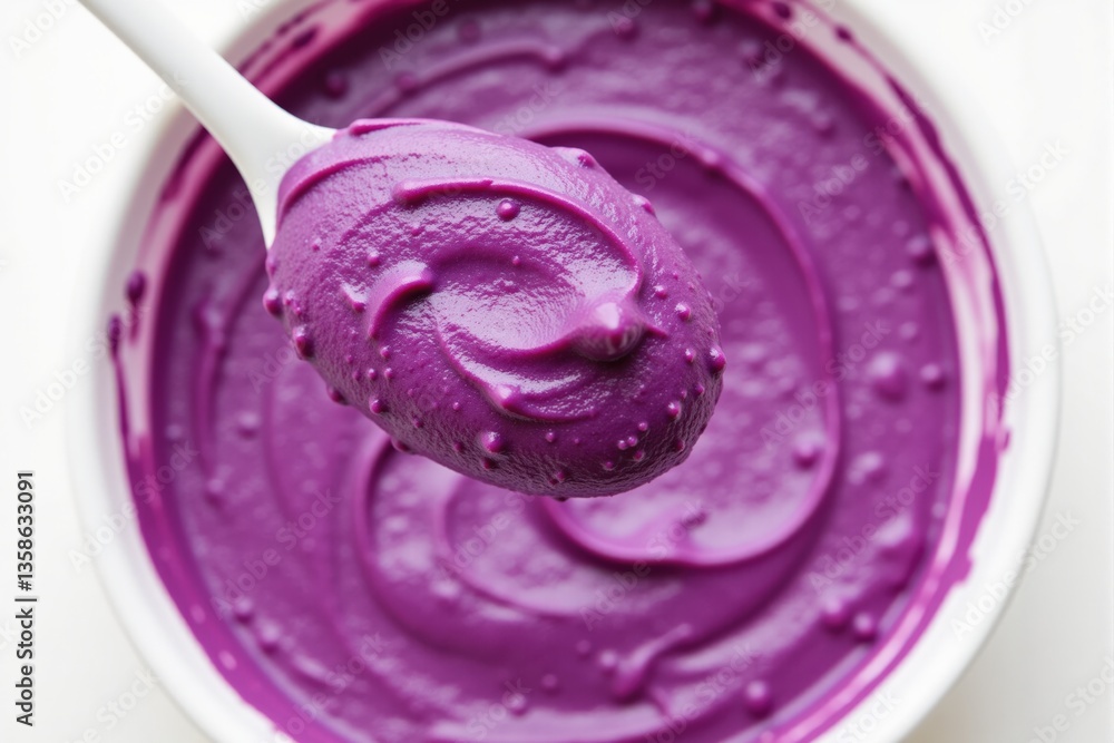 Vibrant Purple Frosting in a Bowl with a Spoon Ready for Decorating Desserts or Cakes, Showcasing a Smooth and Creamy Texture Ideal for Baking Enthusiasts Vibrant Purple Frosting in a Bowl with a Spoon Ready for Decorating Desserts or Cakes, Showcasing a Smooth and Creamy Texture Ideal for Baking Enthusiasts