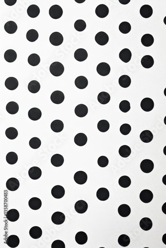 Small black dots printed on white paper background