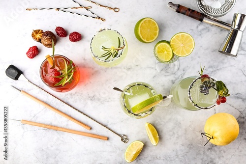 Variety of margarita cocktails with bartender tools overhead shot