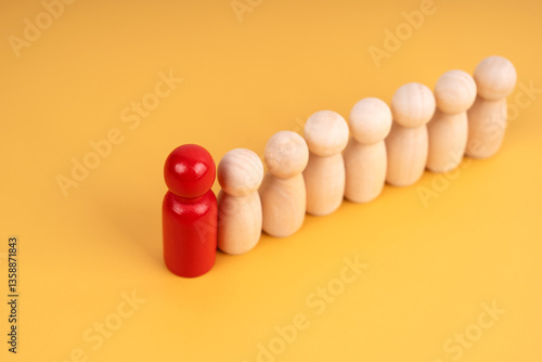 Career growth, development. Leadership, goal achievement. Wooden people figures on yellow background