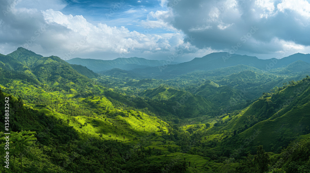 Fototapeta premium Breathtaking Panoramic View of Lush Green Mountains Under a Dramatic Sky with Clouds and Sunlight Casting Shadows Over the Verdant Landscape