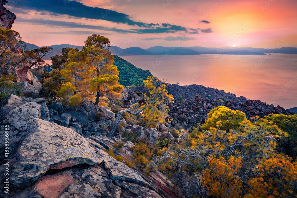 Fantastic summer view of Saronic Islands from popular tourist destination - Methana Volcano. Majestic sunset on Peloponnese peninsula, Greece, Europe. Wonderful Mediterranean seascape.