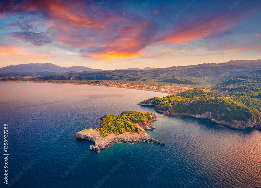 Attractive summer sunset on Saint Basil Beach with Agkali village on background, Nileas, Greece, Europe. Wonderful morning scene of Euboea island. Stunning morning seascape of Aegian sea.