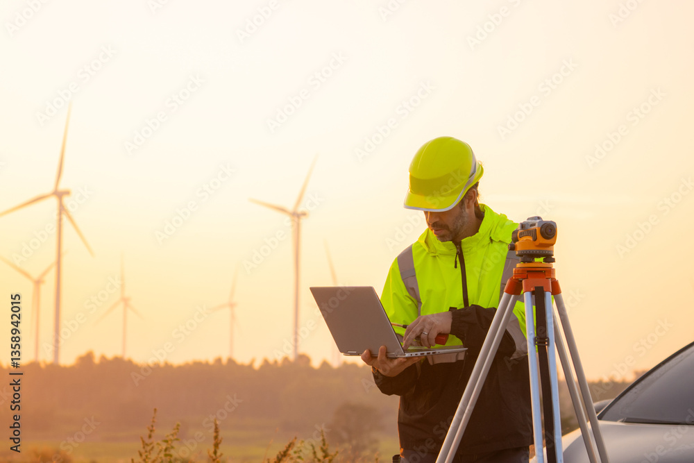 custom made wallpaper toronto digitalEngineer working on laptop in front of wind turbines for checking wind turbines of the field during beautiful sunset. Alternative energy concept.