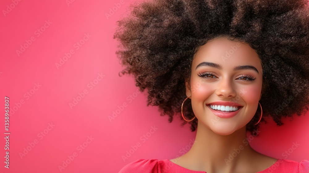 Woman with curly hair is smiling and wearing a red dress. She is laying on a pink background Woman with curly hair is smiling and wearing a red dress. She is laying on a pink background