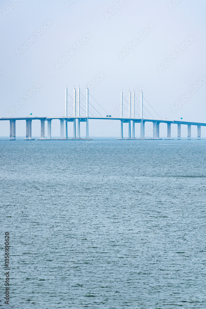 Obraz premium Minimalist Sea and Bridge Landscape with Clean Lines Minimalist seascape with bridge structure crossing calm water. Clean lines and fresh blue tones create a modern aesthetic background.