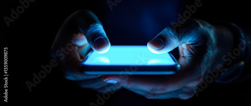 close-up of hands using a glowing smartphone in the dark