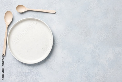 Wallpaper Mural Elegant Empty Plate and Spoons on Light Gray Tabletop - A Minimalist Dining Setting Torontodigital.ca