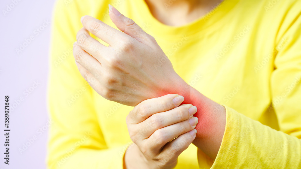 Fototapeta premium Wrist pain chronic therapy concept. A person holding their wrist, showing signs of discomfort or pain.