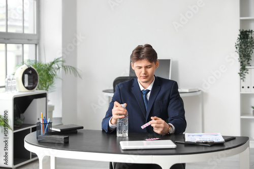 Young businessman with bott...