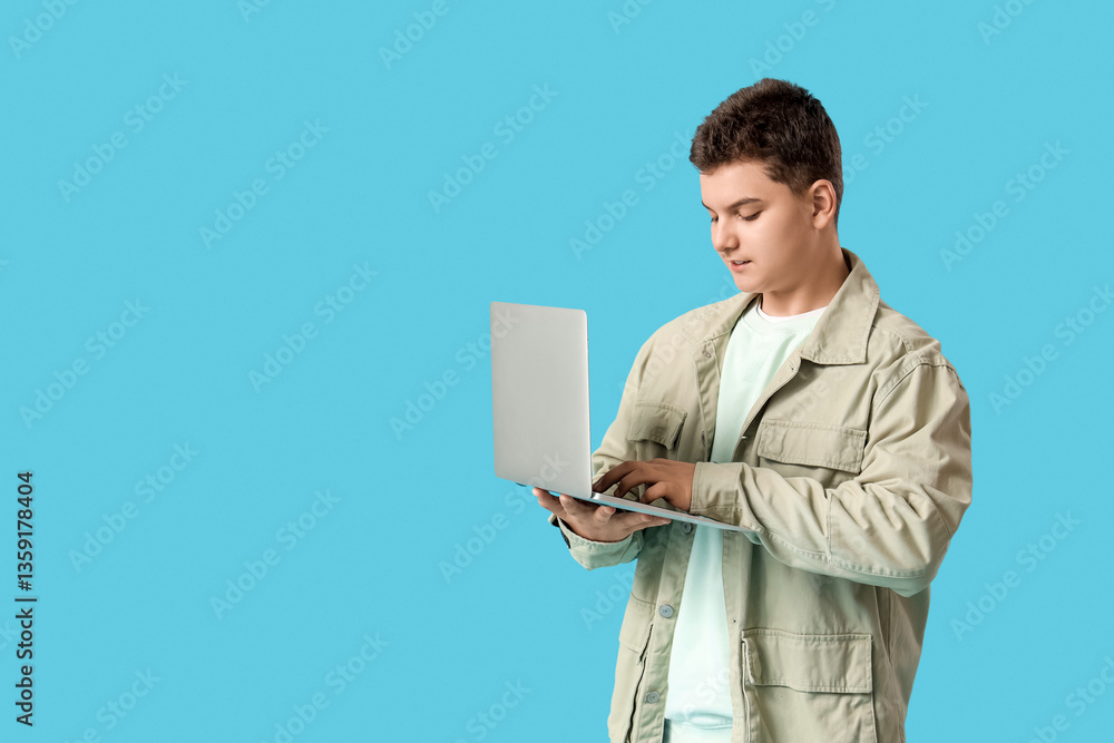 Teenage programmer using laptop on blue background Teenage programmer using laptop on blue background