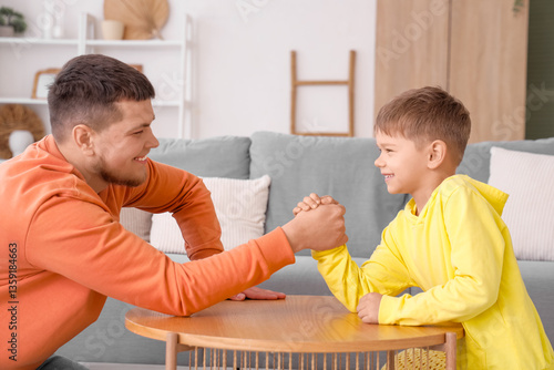 Happy father and son arm wr...