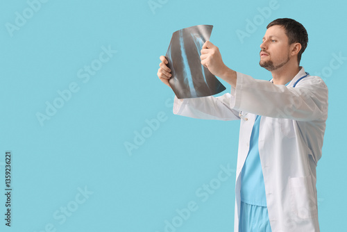 Male doctor studying x-ray ...
