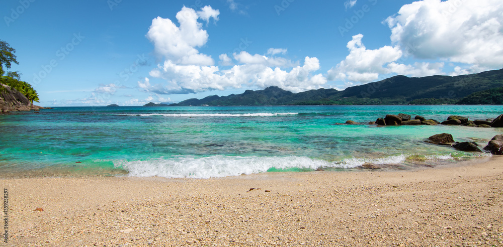 Panoramic View of Tropical Beach with Blue Sky and Clouds. Mahé Island, Seychelles