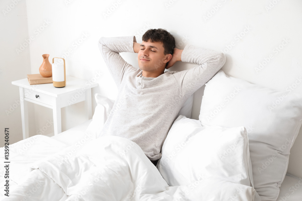 Young man lying in bedroom Young man lying in bedroom