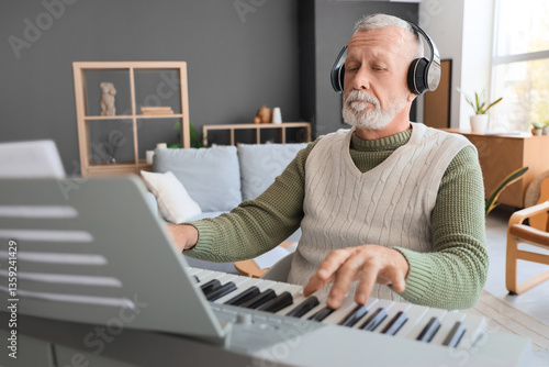Mature man in headphones pl...