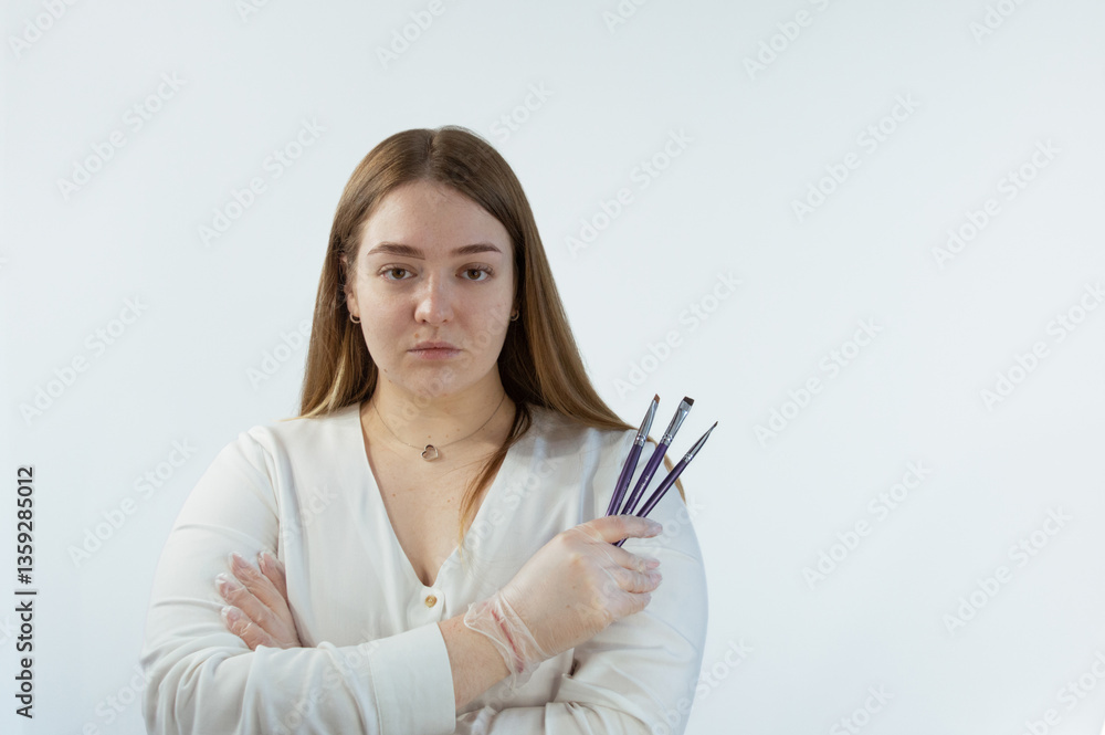 Makeup artist, young woman in studio with brushes in hands in gloves, product or tools for skin. Cosmetic, woman and model with beauty equipment for face cosmetology treatment. Makeup artist, young woman in studio with brushes in hands in gloves, product or tools for skin. Cosmetic, woman and model with beauty equipment for face cosmetology treatment.