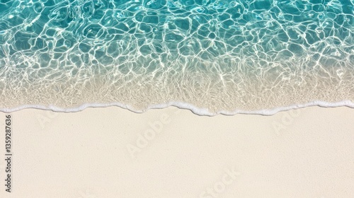 Sparkling turquoise ocean water gently meets the white sandy beach