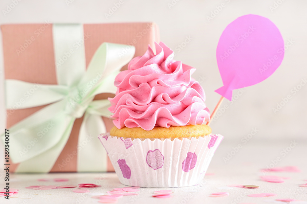 Sweet Birthday cupcake with gift box and confetti on white background Sweet Birthday cupcake with gift box and confetti on white background