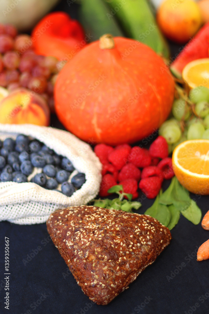 Various healthy fruits, vegetables and cereals on dark background. Selective focus.