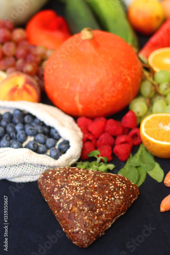 Various healthy fruits, vegetables and cereals on dark background. Selective focus.