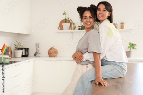 Young lesbian couple huggin...