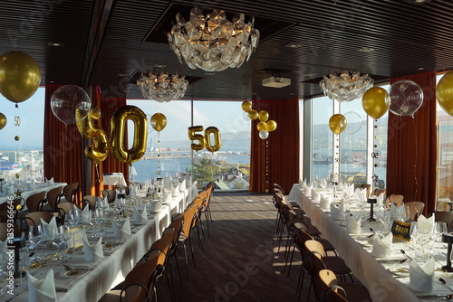 An event venue nicely decorated with golden details for a 50th birthday party