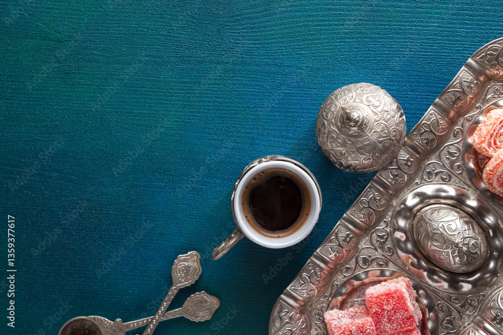 Traditional turkish coffee and turkish delight on wooden table painted blue-green. Flat lay
