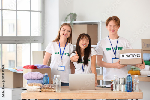 Young volunteers with donat...