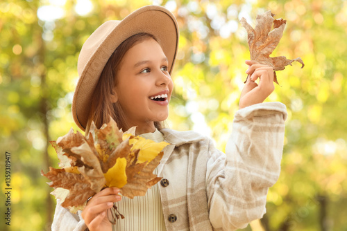 Cute girl with leaves in pa...