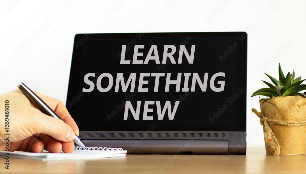 Learn something new symbol. Concept words Learn something new on beautiful tablet. Businessman hand. Beautiful white background. Business motivational lifestyle learn something new concept. Copy space Learn something new symbol. Concept words Learn something new on beautiful tablet. Businessman hand. Beautiful white background. Business motivational lifestyle learn something new concept. Copy space