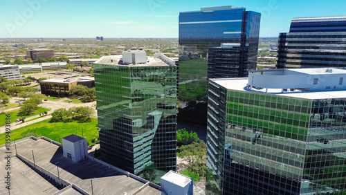 Картината върху платно Glass office building with modern multistorey car park parking multilevel garage