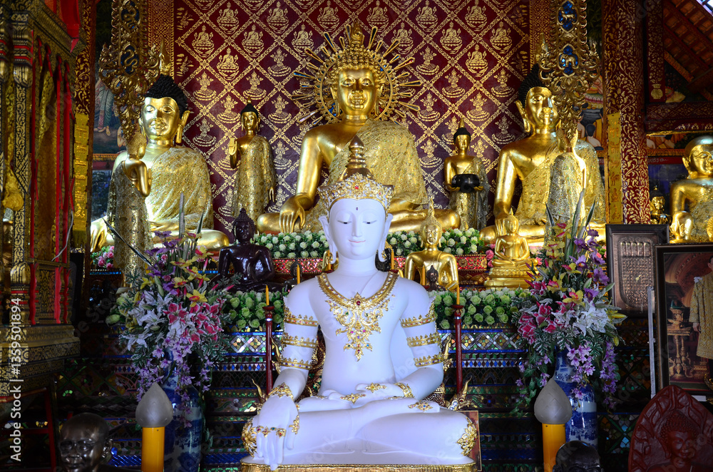 Fototapeta premium Ancient buddha in antique ubosot of Wat Phra Singh or Phra Sing temple for thai people traveler visit respect praying blessing wish myth holy mystical worship at Chiangrai city in Chiang Rai, Thailand