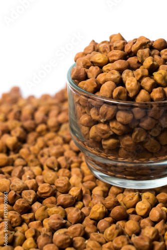 Obraz na plátně Vertical shot of Organic Brown Chickpeas in a Glass Bowl Isolated on a white background