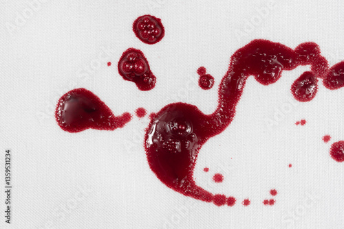 Drops of blood stains on white fabric. blood splatters on clothes. red dripping blood spatters