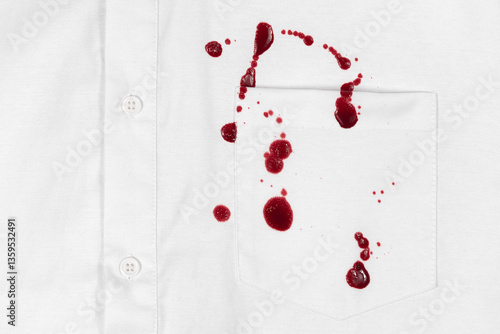 Drops of blood stains on white shirt with a pocket. red dripping splatters on white fabric. blood splatters on clothes.
