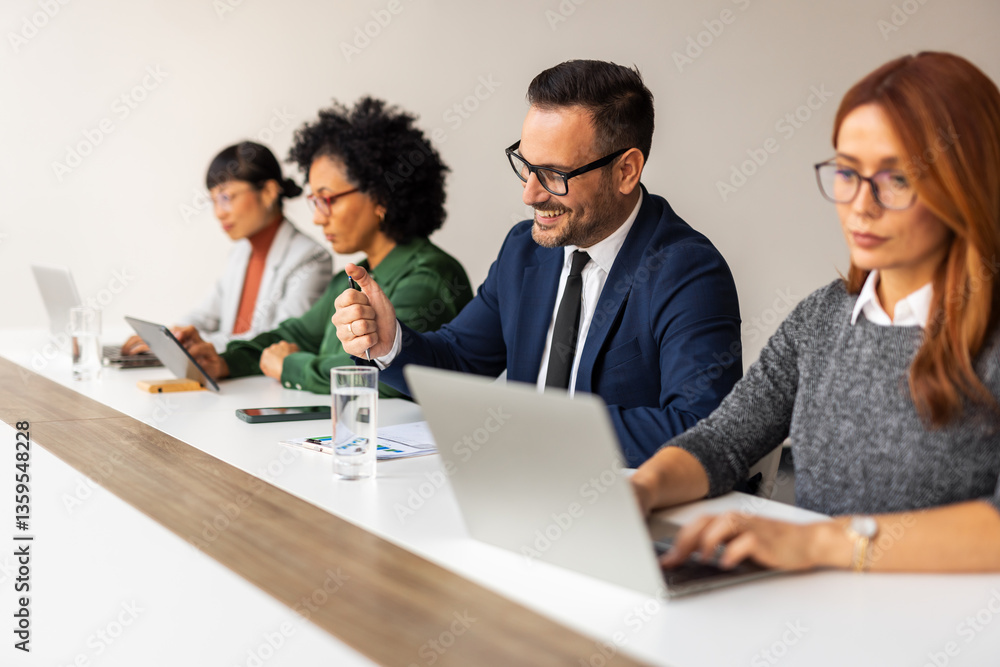 Professional Team in Modern Workspace Collaborating with Laptops and Smiling Together