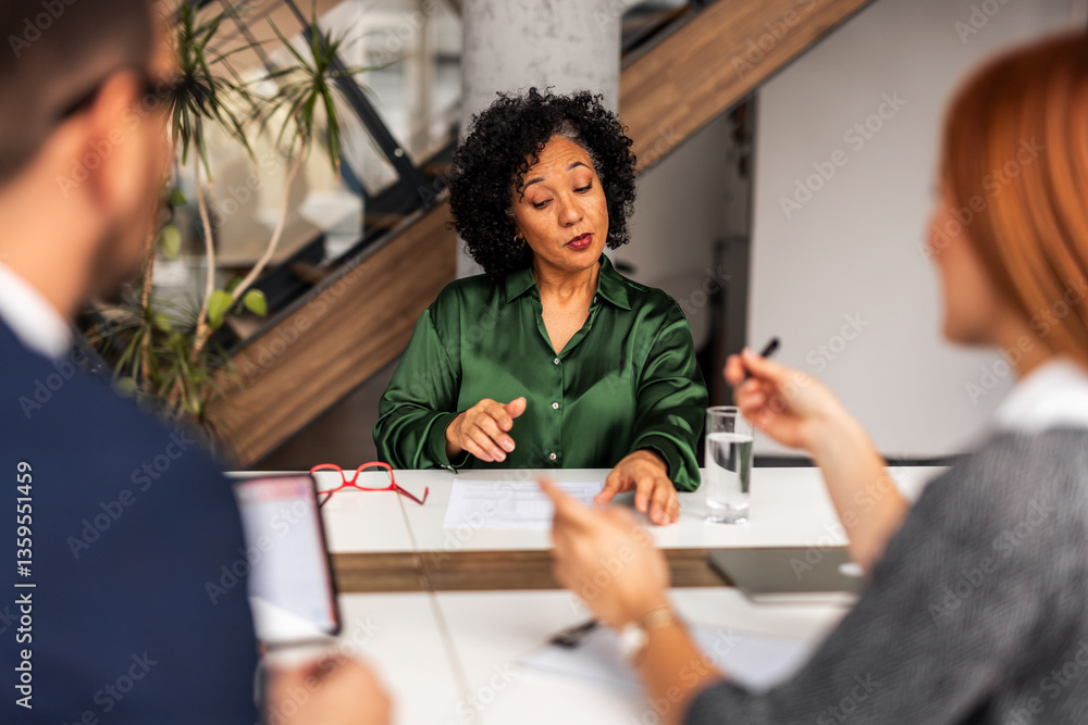 Professional Business Meeting Discussion with Documents in Modern Office Environment