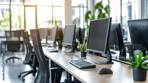 Wallpaper Mural A bright office space with computers chairs and plants in a modern work environment setup Torontodigital.ca