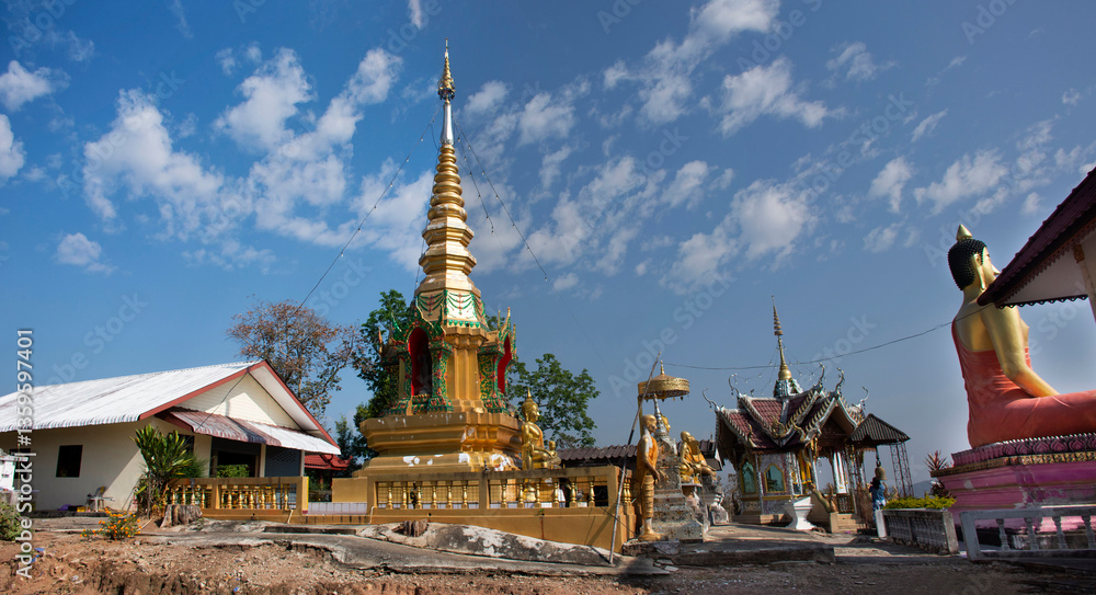 Naklejka premium Stupa chedi and buddha statue images in Wat Phrachao Thanchai and Phra That San Kwang temple at Chiangrai city in Chiang Rai, Thailand