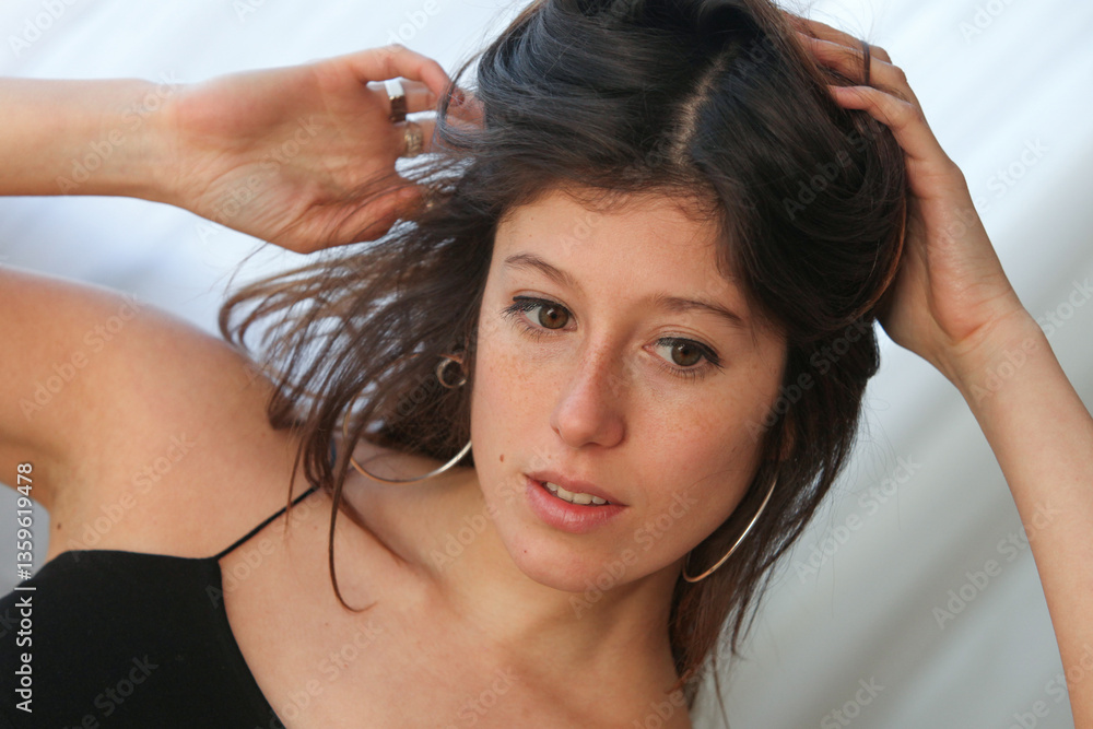 Naklejka premium closeup of young beautiful latino woman with long black hair contemplating