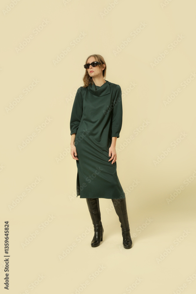 Fototapeta premium Serie of studio photos of young female model wearing green midi dress 